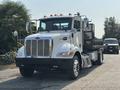 A 2020 Peterbilt 330 medium-duty truck with a white cab chrome grille and multiple orange roof lights on top