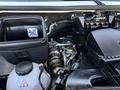 The engine compartment of a 2023 Mercedes-Benz Sprinter 2500 featuring the engine components including the air filter housing and various pipes and tubes