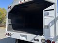 A 2019 Freightliner M2 106 truck with an empty cargo area visible and side compartments with doors