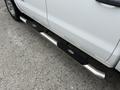A 2016 GMC Sierra 1500 with a chrome side step running board featuring textured black pads for traction