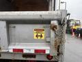 A 2011 Dodge Ram 5500 rear dump truck with a warning sign that states strictly 2 person lift attached to the back of the truck