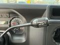 Close-up of the gear shift lever and dashboard indicators in a 2013 Ford Econoline showing the overdrive on/off switch