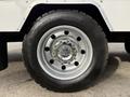Close-up of a 2012 Ford F-550 wheel with a silver rim and black tire featuring a tread pattern suitable for heavy-duty use