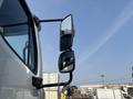 Close-up of the side mirrors on a 2010 Freightliner M2 106 showing multiple reflective surfaces and a sturdy mounting arm