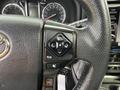 Close-up view of a 2021 Toyota 4Runner steering wheel with control buttons and a textured grip