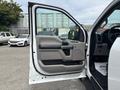 A 2017 Ford F-150 with the driver's door open showcasing the interior design and control panel