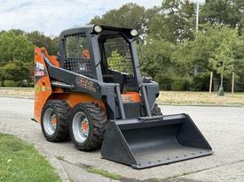 A 2017 Gehl R105 skid steer loader with large wheels and a bucket attachment in the front