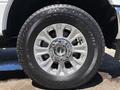 A close-up of a silver alloy wheel with a Bridgestone tire showcasing its tread and detailed wheel design