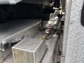 A section of a 2016 RAM 5500 showing the undercarriage with a metallic surface battery box and a valve connection with colored indicators