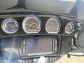 A close-up view of the dashboard of a 2017 Harley-Davidson FLHTKL featuring gauges for speedometer fuel level and temperature along with a central display screen