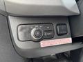 A control panel featuring a dial for adjusting headlights and additional buttons for vehicle settings in a 2020 Mercedes-Benz Sprinter 2500