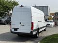 A 2023 Mercedes-Benz Sprinter van in white with a sleek design and rear doors open for access