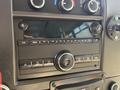 Dashboard control panel of a 2020 Chevrolet Express featuring audio controls and a display screen