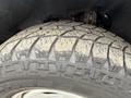 Close-up of a worn tire tread on a 2016 RAM 1500 showcasing deep grooves and rugged texture
