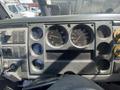 Dashboard of a 1997 Freightliner FL70 featuring gauges for RPM speed and fuel along with control switches