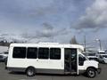 A white 2018 Chevrolet Express shuttle bus with an open door and large windows on the side
