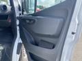 A 2025 Mercedes-Benz Sprinter passenger side door interior featuring a black plastic panel with a handle and storage compartment