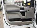 The image shows the interior door panel of a 2018 Ford F-550 featuring a gray and black color scheme with a handle window controls and speaker area