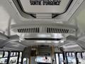 Interior view of a 2017 Chevrolet Express showing the ceiling with air vents and an emergency exit sign