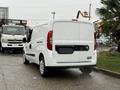 A white 2017 RAM ProMaster City van is parked with its rear view facing the camera showcasing its sleek design and logo