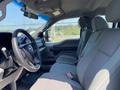 Interior of a 2017 Ford F-250 SD featuring gray cloth seats a steering wheel and a dashboard with controls and displays