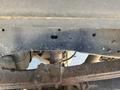 Close-up view of the undercarriage of a 2016 Ford F-250 SD showing the metal frame with visible wear and several drilled holes in it