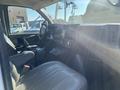 Interior view of a 2011 Chevrolet Express with a driver's seat and dashboard displaying controls and features