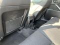 Interior view of the back seat of a 2006 Pontiac G6 featuring black fabric upholstery and storage pockets on the seatbacks