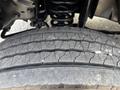 Close-up of a heavily worn tire with visible cracks and tread wear showing extensive use