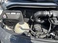 An engine compartment of a 2010 Mercedes-Benz Sprinter showcasing various components including an air filter a reservoir and hoses