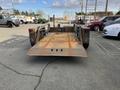 2013 JLG Industries Flat Deck Trailer with a flat bed and metal frame visible from the rear showing the loading area