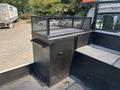 A black metal utility box with a mesh top secured on the back of a 2006 Sterling Acterra truck designed for storage and tool organization