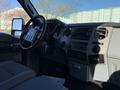 Interior of a 2010 Ford F-450 featuring a steering wheel dashboard and control panel with audio and climate controls