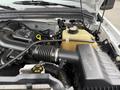 Detail of the engine bay of a 2008 Ford F-250 SD showing the air intake duct and coolant reservoir with various hoses and components visible