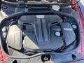 An engine compartment of a 2015 Bentley Continental GT featuring a large V8 engine with sleek covers and intricate detailing
