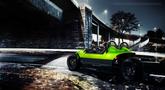 A vibrant green 2024 Vanderhall Carmel sports car with sleek lines and a minimalist design parked on a road