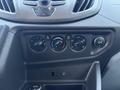 Dashboard controls of a 2016 Ford Transit 150 featuring knobs for temperature adjustment fan speed air conditioning and a 12V power outlet
