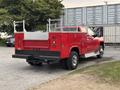 Red 2015 Chevrolet Silverado 3500HD with a truck bed and utility features visible in the foreground