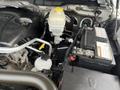 The image shows the engine compartment of a 2015 RAM 2500 with various components including the battery coolant reservoir and engine parts in focus