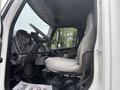 A 2006 Freightliner M2 106 interior showing the driver's seat dashboard and gear shift with a steering wheel in view