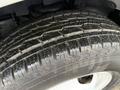 Close-up of a tire on a 2015 Chevrolet Express showing tread patterns and wear on the rubber surface