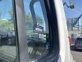 A 2014 Freightliner M2 106 truck visible through a window with a certification sticker applied to the glass