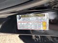 A sticker on the inside of a 2014 Honda CR-V detailing tire and loading information including size pressure and seating capacity