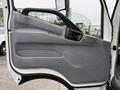 The image shows the interior side of the driver's door of a 2015 Hino 195 featuring a gray door panel with a handle and window controls