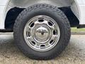 Close-up of a shiny chrome wheel and tire on a 2020 Ford F-150 showcasing the detailed design of the rim and rugged tread pattern of the tire