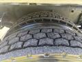 Close-up of a heavily treaded tire on a 2022 Freightliner M2 106 showing visible wear patterns and texture on the rubber surface