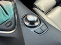 A close-up of the climate control dial in a 2004 BMW 6-Series interior with buttons for sport mode menu and air distribution