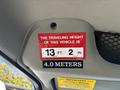A warning label inside a vehicle displaying the traveling height of the vehicle as 13 feet 2 inches and 4.0 meters