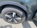 Close-up of a black alloy wheel on a 2022 Kia Sorento featuring a modern design and distinctive multi-spoke pattern with a radial tire