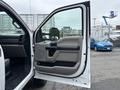A 2018 Ford F-550 truck with the driver's side door open revealing the interior and dashboard details